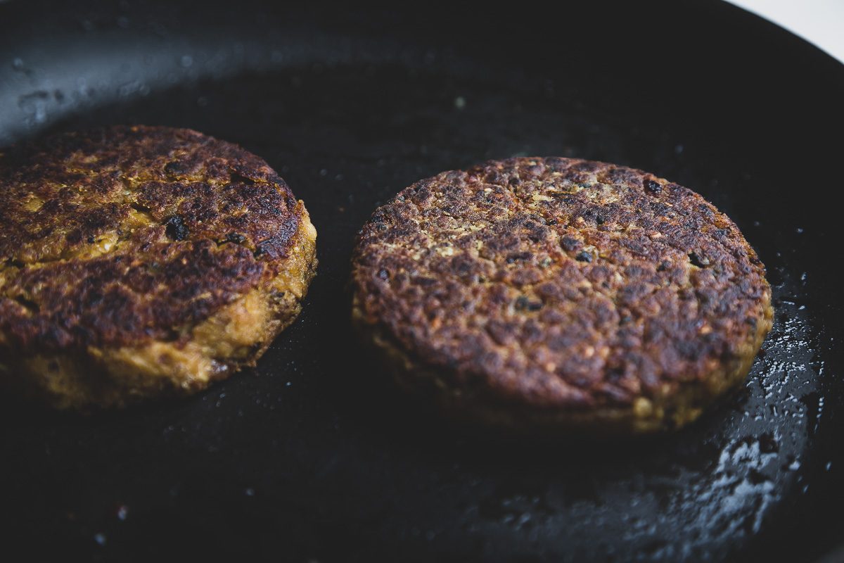 delicious vegan burger patties in a skillet | sultryvegan.com
