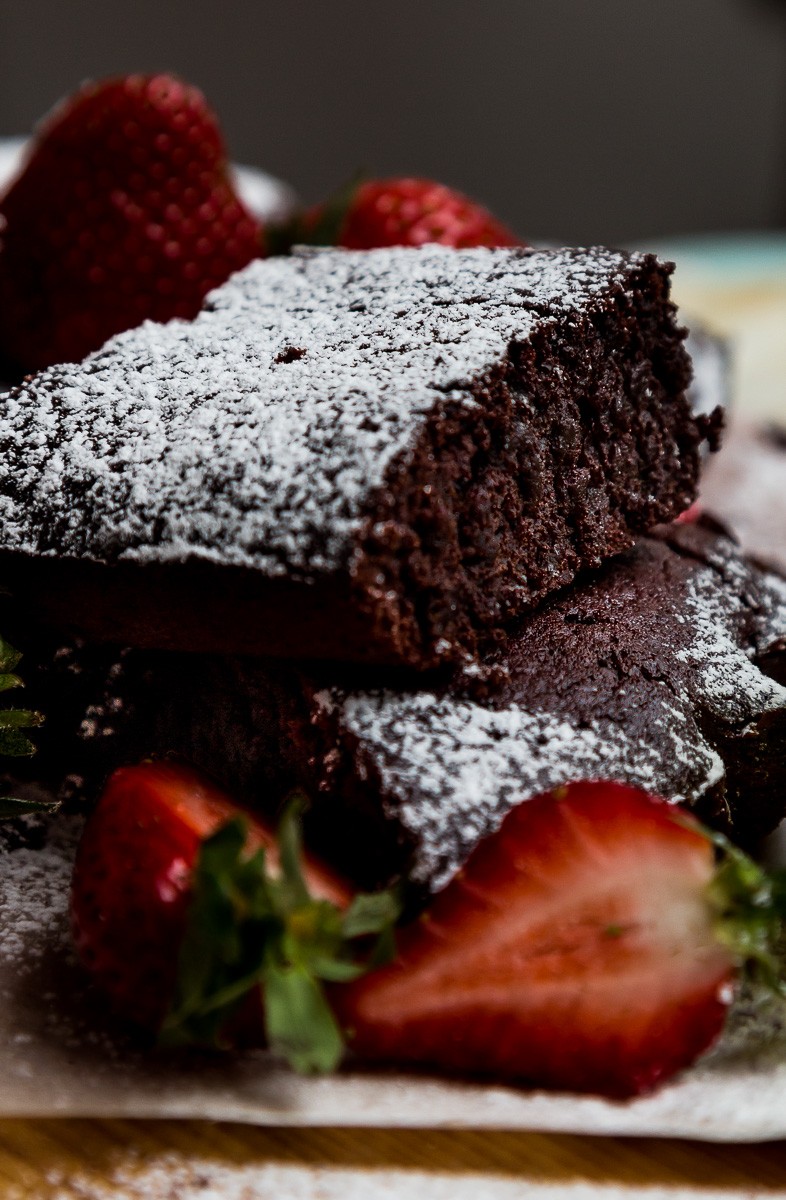 beetroot brownie squares piled up with fresh strawberries | sultryvegan.com