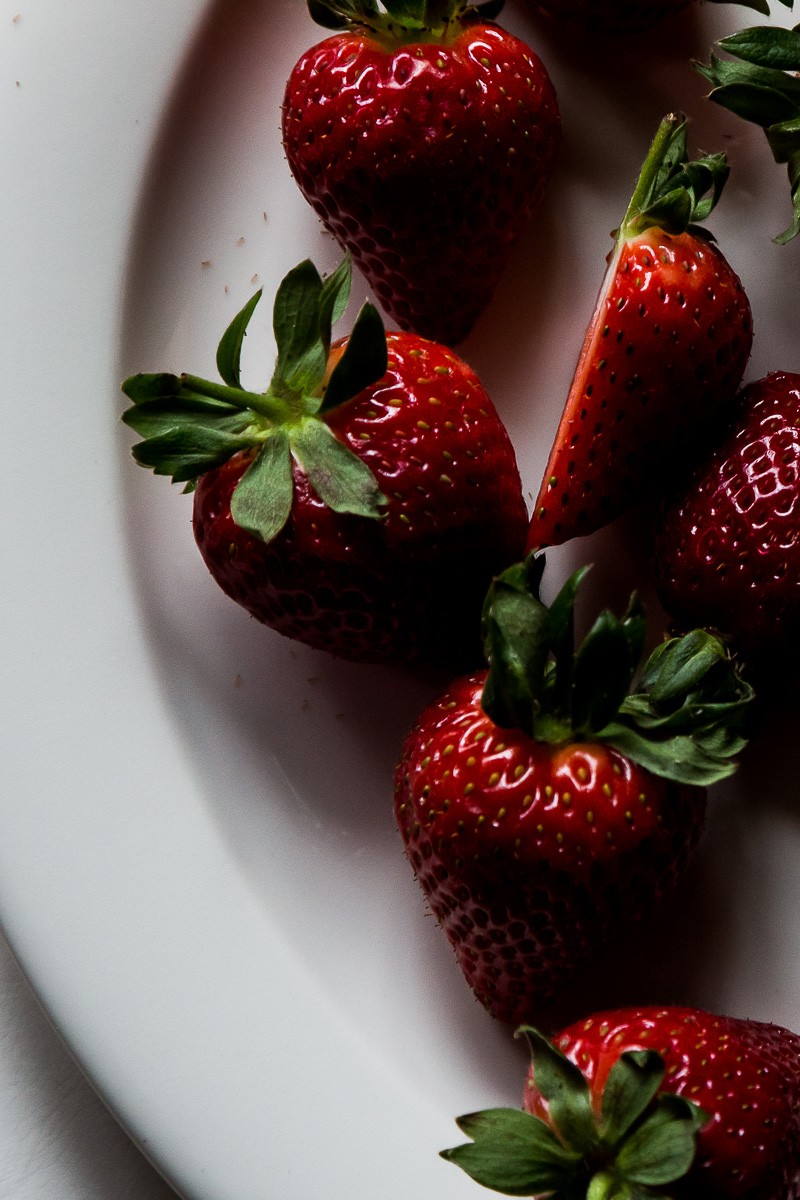 fresh bright strawberries on a white plate | sultryvegan.com