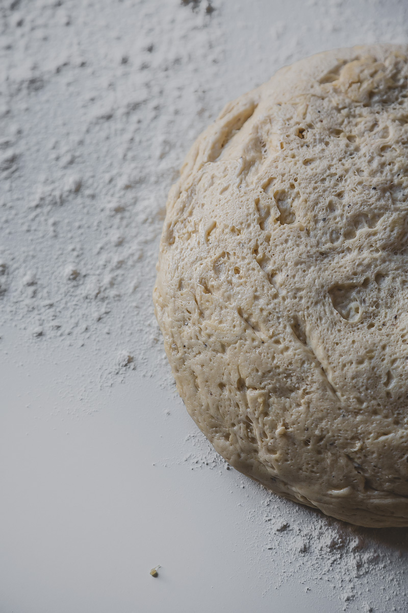 cinnamon bun dough poured on white flour dusted table