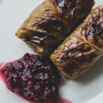 Savoy cabbage rolls plated with lingonberry jam.