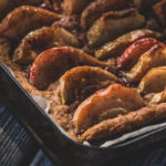 A close up of an apple pie fresh out of the oven.